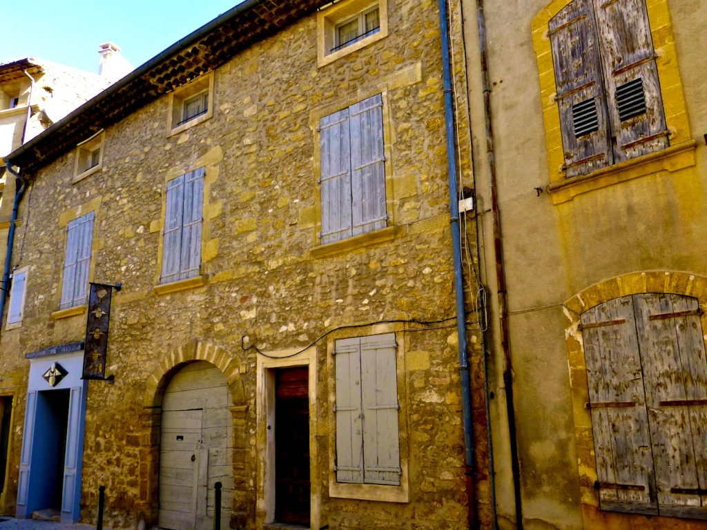 Shutters of Provence on medieval buildings in Lourmarin, Luberon, Provence, France