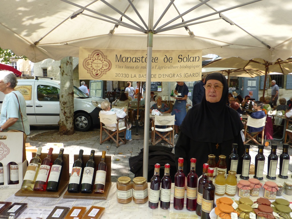 Nun selling wine at Wednesday Market in Uzes,Languedoc Rousiilon, France