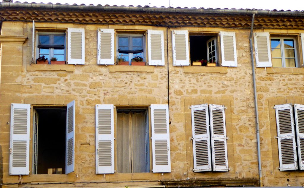 Shutters of Provence above a cafe in Lourmarin Provence, France