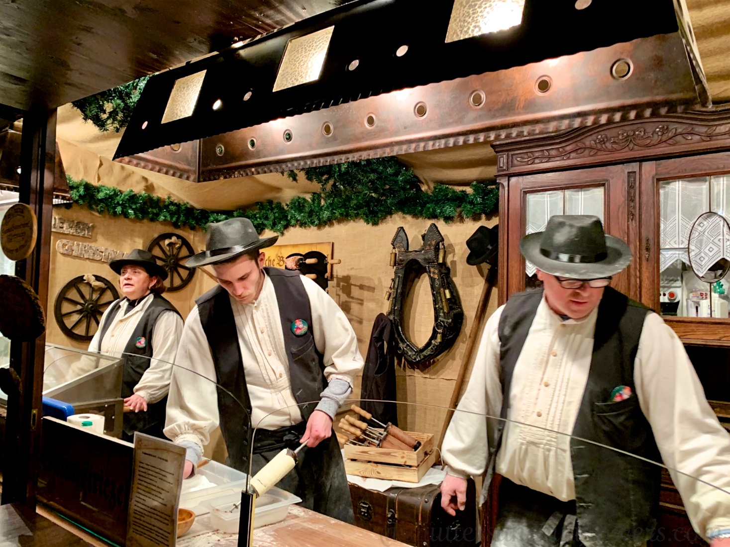 Strudel bakers dressed in traditional dress at the Cologne Christmas market