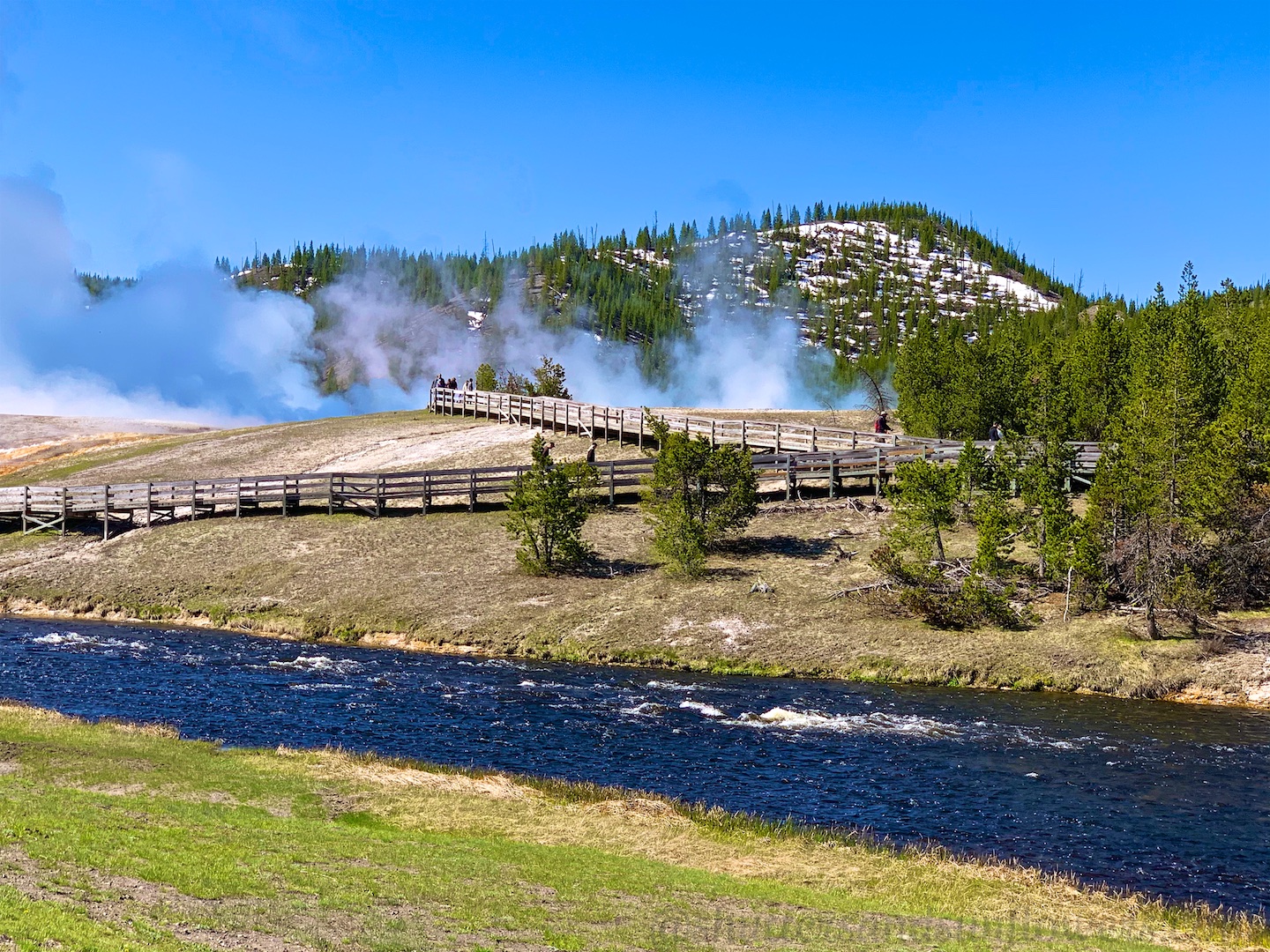 The steaming Midway Geyser Basin, by The Firehole River at Yellowstone National Park