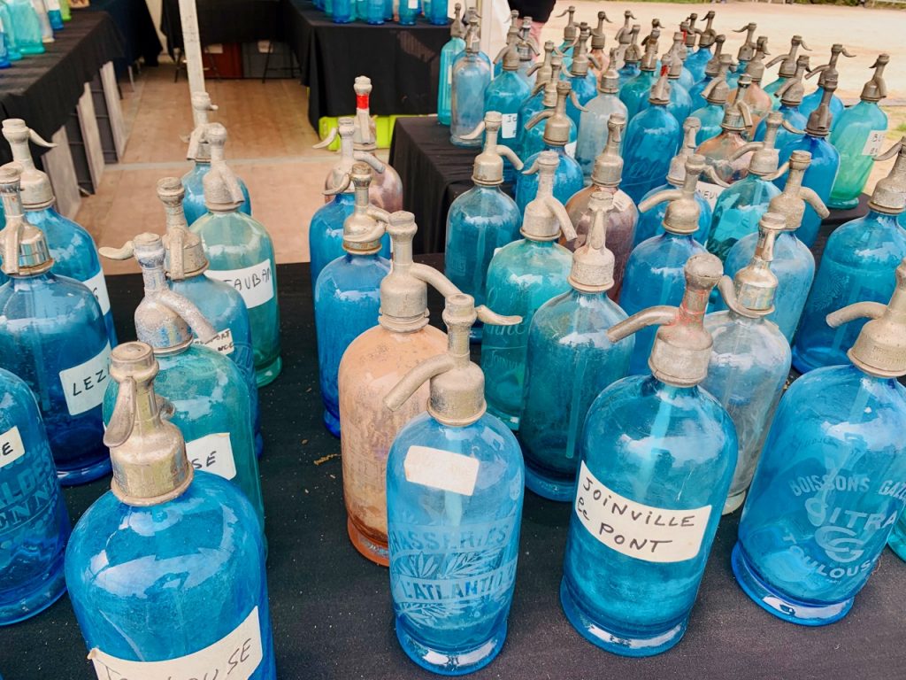 Water syphons for sale at l'Isle sur la Sorgue Spring Antiques Fair, Luberon, Vaucluse France